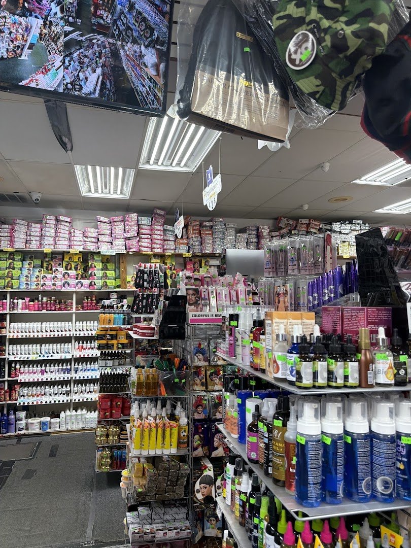 Shelves stocked with braid hair and cosmetics.