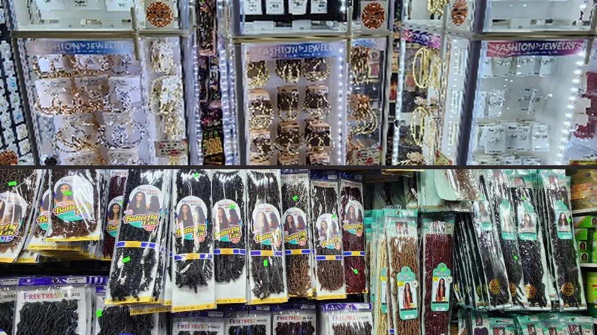 Shelves stocked with braid hair and cosmetics.